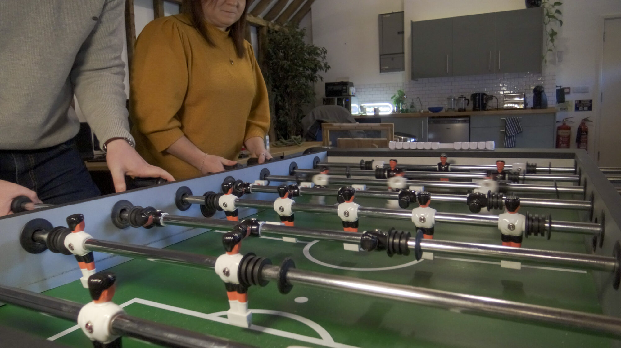 Two SEO experts playing table football