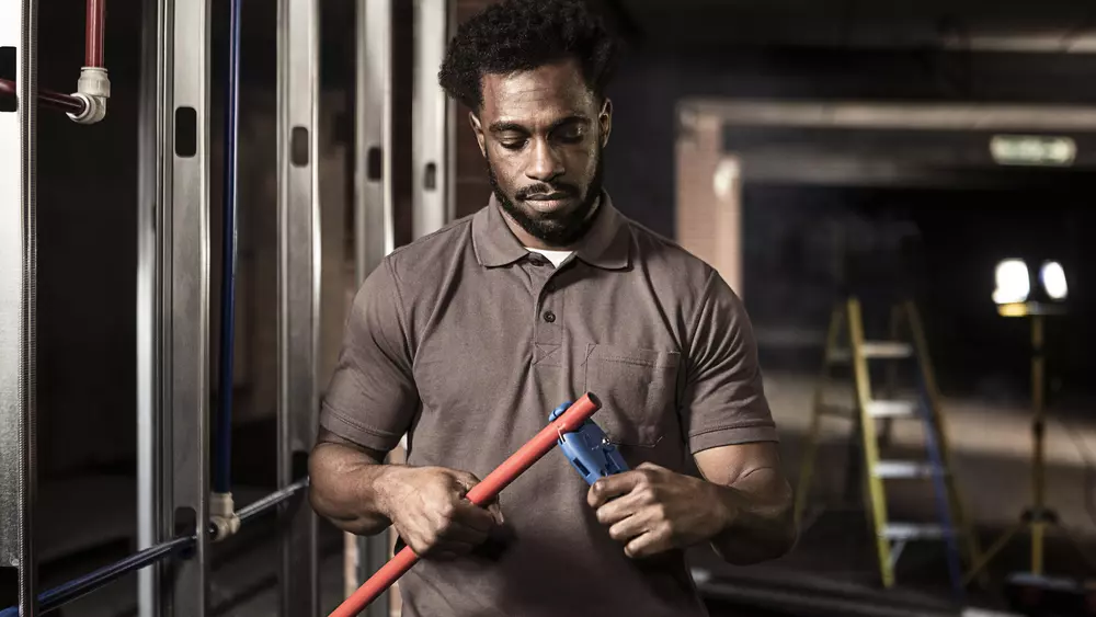 man cutting pipe - john guest manufacturing seo case study